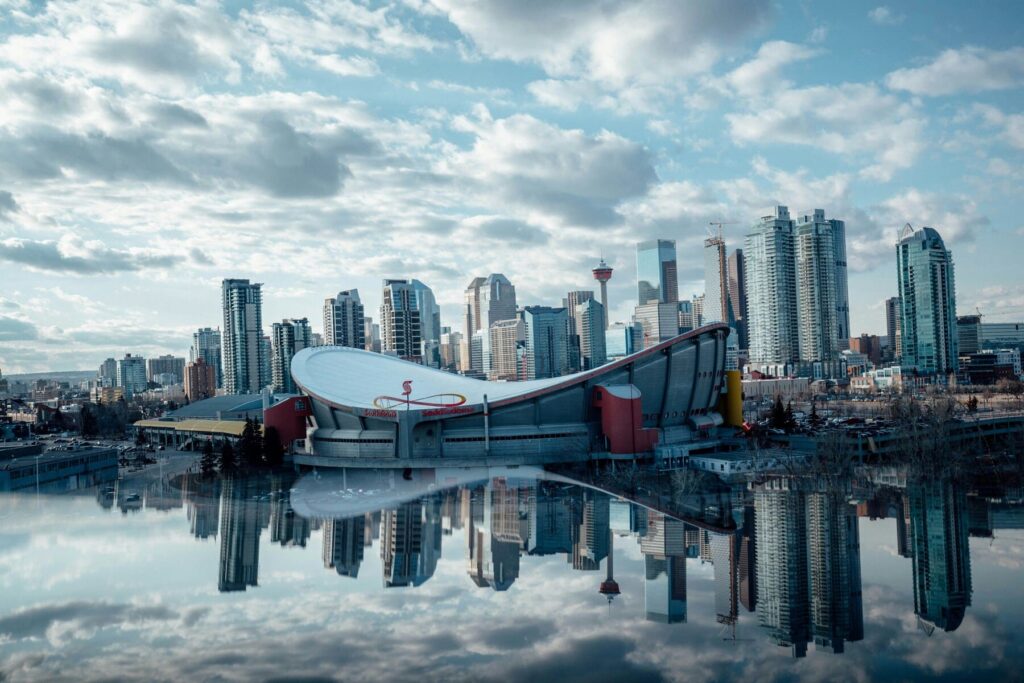 A view of Downtown Calgary skyline featuring the Scotiabank Saddledome, representing Tam-Crete Engineering's structural engineering service area.